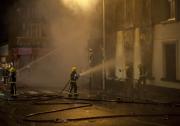 Firefighters in Croydon, south London, try to put out a building set on fire by rioters. Photo: tgeasland/Flickr